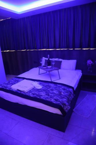a bedroom with a bed with a table on it at Del Mare Park in Kérynia