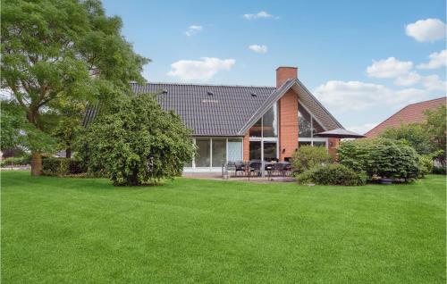 a house with a green lawn in front of it at Stunning Home In Nyborg With Sauna in Nordenhuse