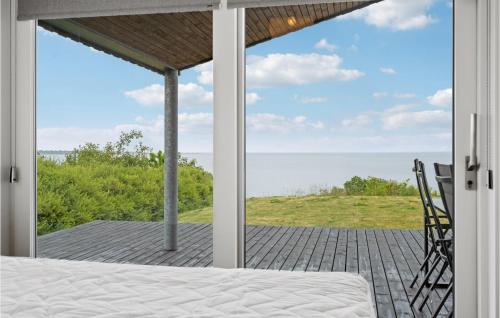 a bedroom with a view of the ocean at 4 Bedroom Nice Home In Haderslev in Haderslev