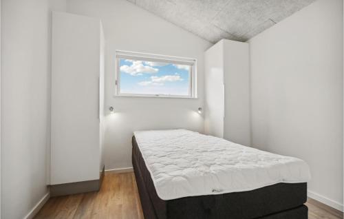 a white room with a bed and a window at 4 Bedroom Nice Home In Haderslev in Haderslev
