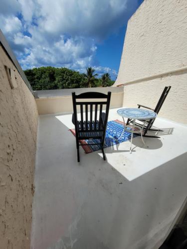 two chairs and a table on a balcony at Sea Turtle Condo with Loaded Amenities in Christiansted
