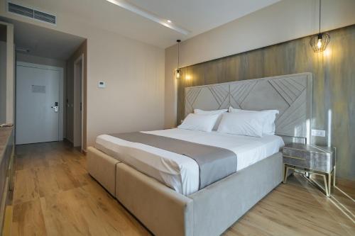 a bedroom with a large bed and a glass table at Brilliant Hotel & SPA in Golem
