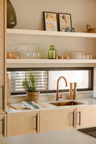 a kitchen counter with a sink and a window at Kerami Kefalonia in Kefallonia