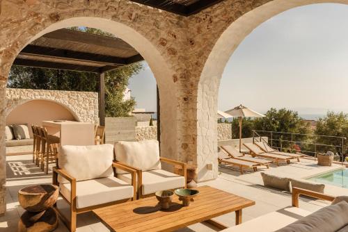 an outdoor patio with chairs and a table at Kerami Kefalonia in Kefallonia