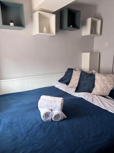 a bedroom with two beds and towels on the floor at Tiny Studio Universitate in Craiova