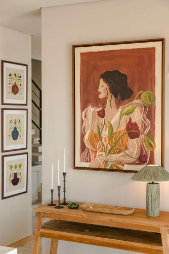 a painting of a woman on a wall with a table at Kerami Kefalonia in Kefallonia