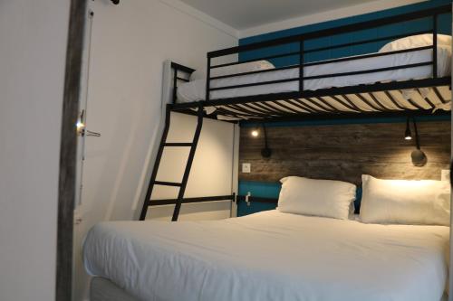 a bedroom with a bunk bed and a ladder at Fasthotel Albertville in Albertville