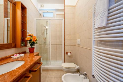 a bathroom with a shower and a toilet and a sink at Approdo Sul Mare Bari Apartment in Bari
