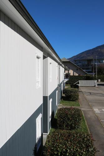 a white building with a row of windows on it at Fasthotel Albertville in Albertville