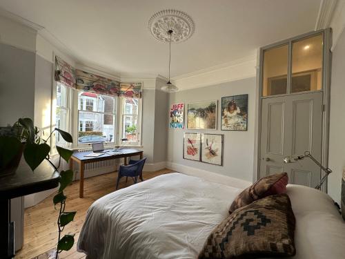 a bedroom with a bed and a desk in it at 2 bed luxe garden apartment in London