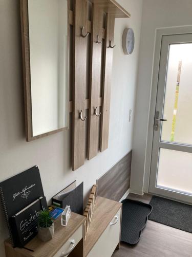 a room with a desk and cabinets and a window at Ferienhaus Joschko in Bad Arolsen