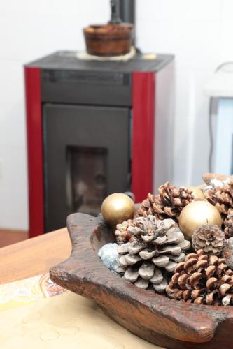a wooden tray with christmas decorations on a table at casa margherita in Pieve di Teco