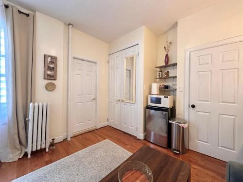 a living room with a door and a microwave at Urban Luxury Hudson River Suite in New York