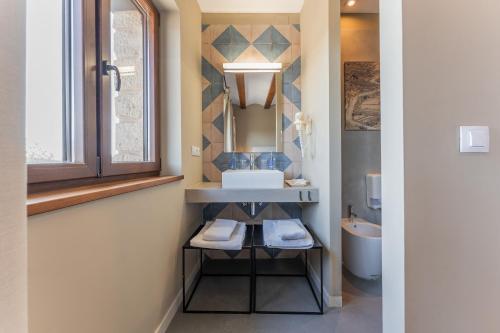 a bathroom with a sink and a mirror at Hotel Mas De Cebrian in Puertomingalvo