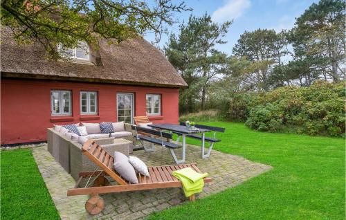 a house with a patio with a table and a bench at Pee Klims Hus in Brovst