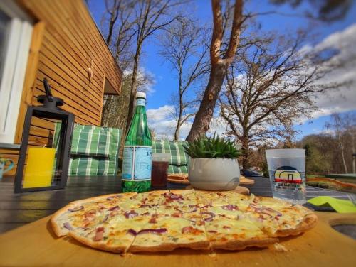 a pizza sitting on top of a wooden table at Ferien im Tiny House in Stuer