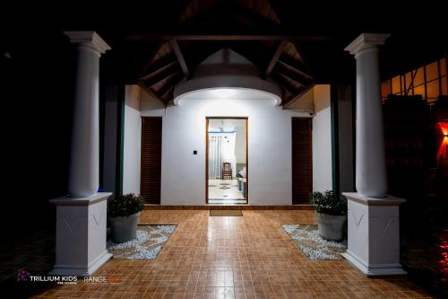 a hallway with columns and a door in a building at Casa Suite Seenigama - Hikkaduwa in Hikkaduwa