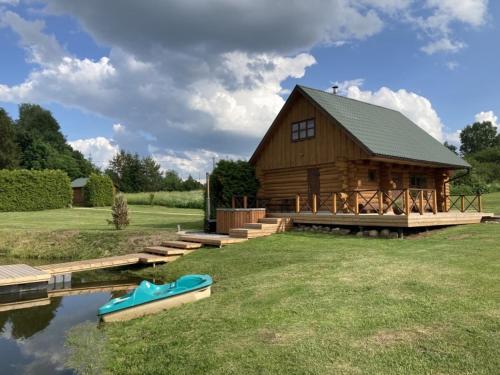 a log cabin with a boat in front of it at Tatra Holiday House in Tatra