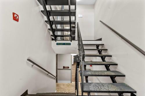 a stair case in a building with stairs and a sign at Green Harbor Hotel in Marshfield