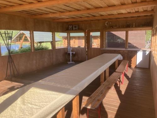 a large long table in a room with a bench at Tatra Holiday House in Tatra