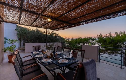 a dining table on a patio with a view of the ocean at Beautiful Home In Prigradica in Prigradica
