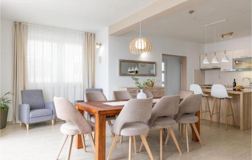 a dining room and kitchen with a table and chairs at Beautiful Home In Prigradica in Prigradica