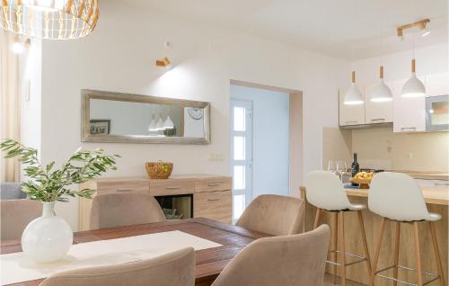 a kitchen and dining room with a table and chairs at Beautiful Home In Prigradica in Prigradica