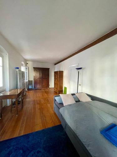 a bedroom with a bed and a table in it at Appartamento sui tetti del centro storico in Rovereto