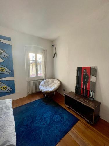a room with a bed and a blue rug at Appartamento sui tetti del centro storico in Rovereto