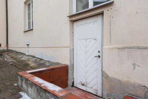 a white door on the side of a building at Aura Spa in Vilnius