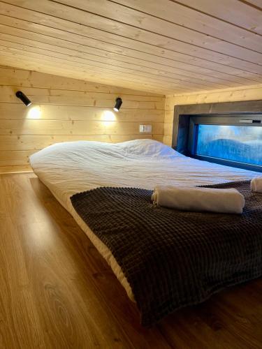 a bedroom with a large bed in a wooden room at Flow Hill in Kościelisko