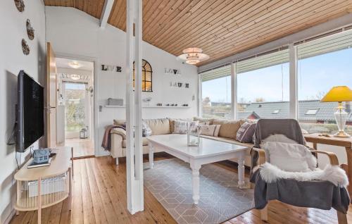 a living room with a couch and a table at 3 Bedroom Nice Home In Roslev in Roslev