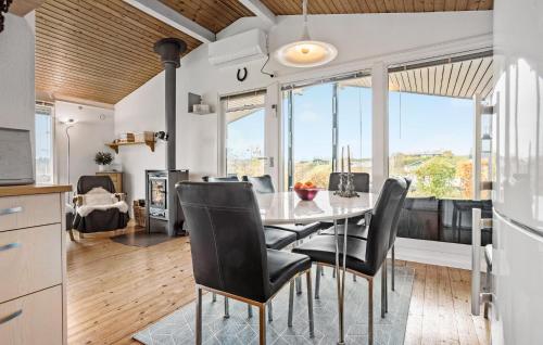 a kitchen and dining room with a table and chairs at 3 Bedroom Nice Home In Roslev in Roslev