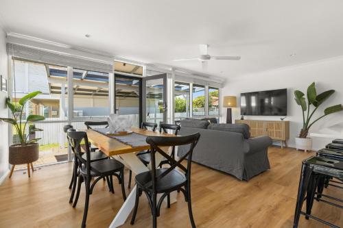 a living room with a table and a couch at OnPoint at Vincentia in Vincentia