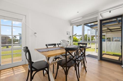 a dining room with a table and chairs at OnPoint at Vincentia in Vincentia