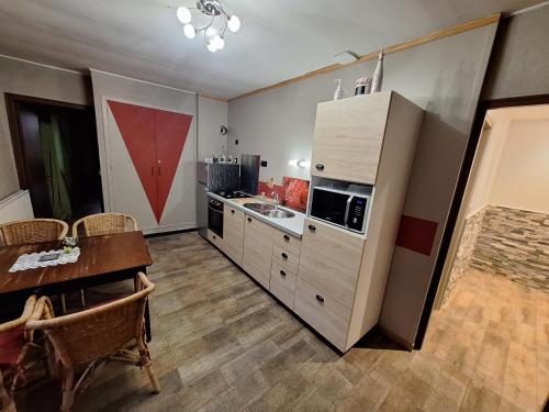 a kitchen with a table and a counter top at Gîte De La Souris Verte in Molamboz