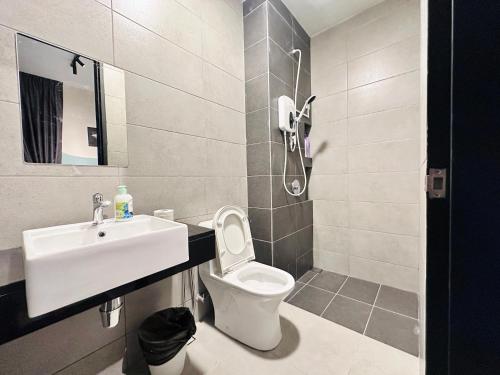 a bathroom with a toilet and a sink at 2 bed room 5 queen bed luxury sea view apartment in Jelutong