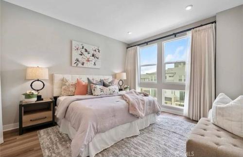 a bedroom with a bed and a large window at 1311WCara in Anaheim