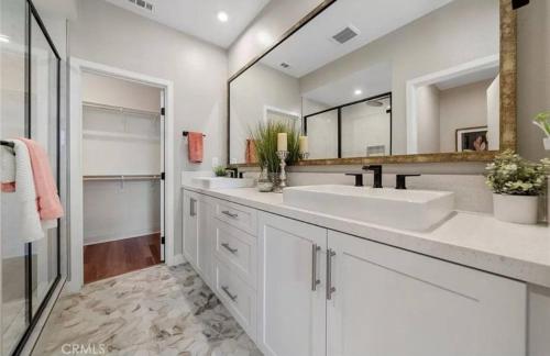 a bathroom with two sinks and a large mirror at 1311WCara in Anaheim