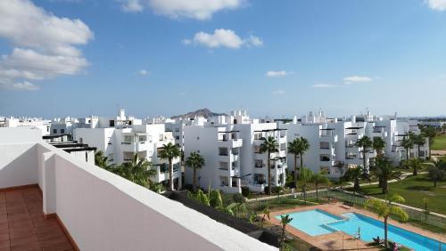 arial view of a white apartment building with a swimming pool at Sunnydays in Roldán