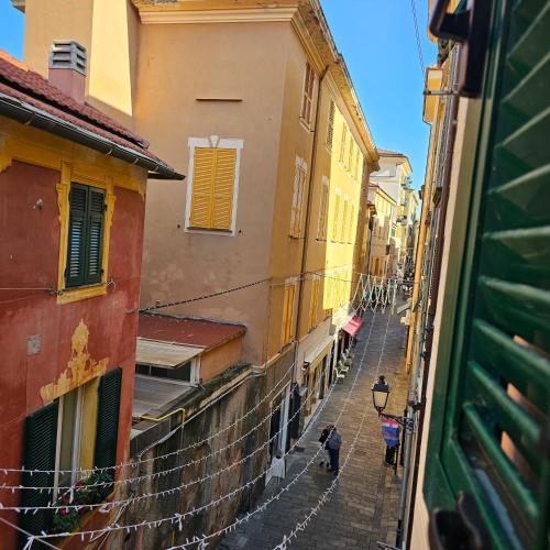 a view of an alley with people walking down the street at Casa Alessio, luminosa, centrale, ad un passo dal mare in Varazze