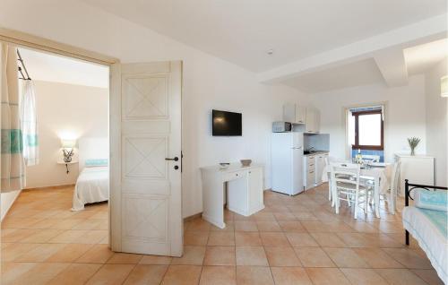 a living room with a door open to a kitchen at Vignola Baia Dei Mirti M3 in Vignola Mare