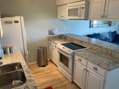 a kitchen with a counter top and a refrigerator at Jimmy's Beach Condo in Emerald Isle