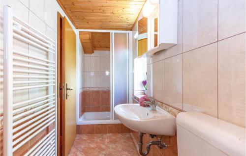a bathroom with a sink and a toilet and a tub at Two-Bedroom Holiday Home In Tucepi in Tučepi
