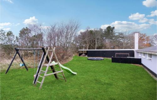 a yard with a swing and a frisbee at Cozy Home In Skagen With Kitchen in Skagen