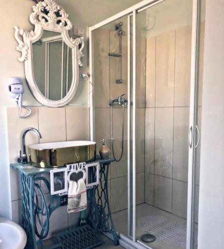 a bathroom with a shower with a sink and a mirror at La Dimora Porto economy in Gioia Tauro
