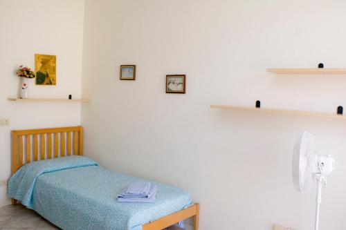 a bedroom with a bed and shelves on the wall at Summer apartment in Viareggio