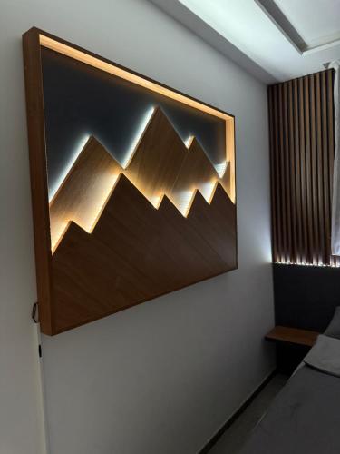 a room with a picture of mountains on the wall at Duspara lux apartment Jahorina in Jahorina