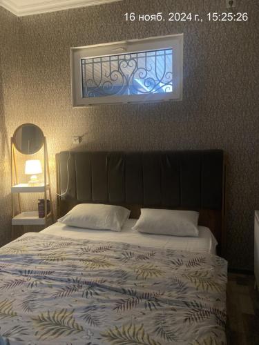 a bedroom with a large bed with a window at Anna'S Home in Kutaisi