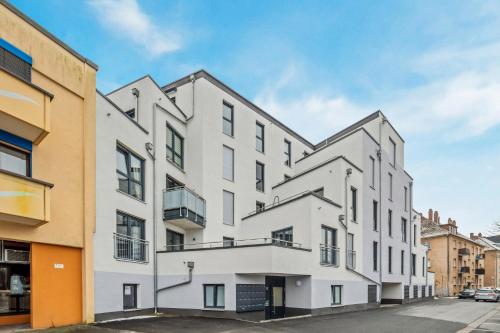 an image of a white building at Sali Homes - AM2 Spacious Apartment with Terrace in City Center in Bayreuth
